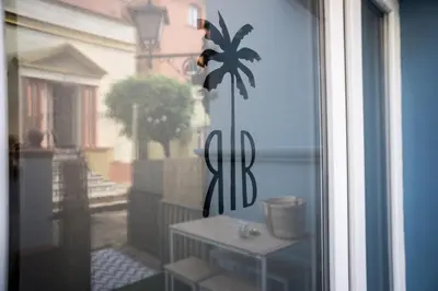 a window with a view of a balcony with a table at R&B Puerto Sherry Abohem in El Puerto de Santa María