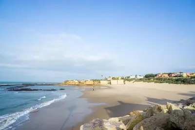 a view of a beach with rocks and the ocean at R&B Puerto Sherry Abohem in El Puerto de Santa María