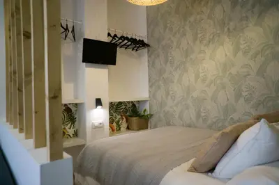 a bedroom with a bed and a tv on a wall at R&B Puerto Sherry Abohem in El Puerto de Santa María