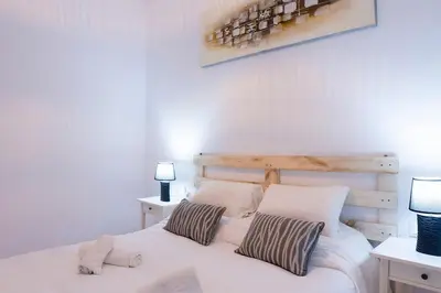 a bedroom with a white bed with two pillows at CDZ - Suarez de Salazar 1 y 2 in Cádiz