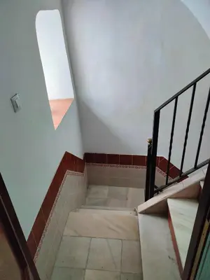 a set of stairs in a building with a window at CDZ - Suarez de Salazar 1 y 2 in Cádiz
