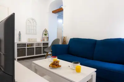 a living room with a blue couch and a table at CDZ - Suarez de Salazar 1 y 2 in Cádiz