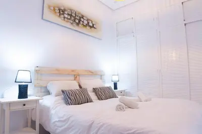 a white bed with two pillows on it in a bedroom at CDZ - Suarez de Salazar 1 y 2 in Cádiz