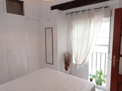 a white bedroom with a bed and a window at CDZ - Suarez de Salazar 1 y 2 in Cádiz