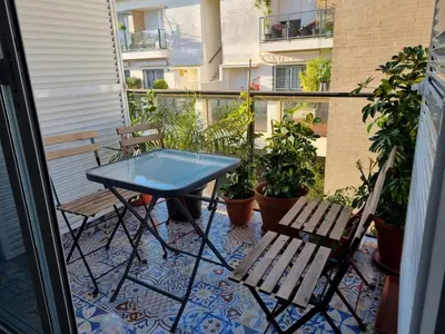 a blue table and two chairs on a balcony at Atico Capuchinos in Sanlúcar de Barrameda