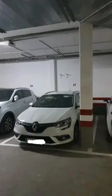 a white car parked in a parking garage at Atico Capuchinos in Sanlúcar de Barrameda