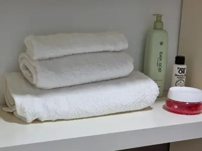 a pile of white towels sitting on a shelf at Atico Capuchinos in Sanlúcar de Barrameda