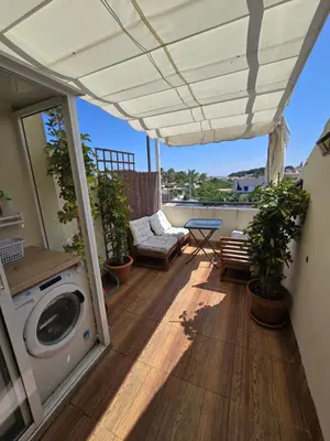 a patio with a washer and dryer on a balcony at Atico Capuchinos in Sanlúcar de Barrameda