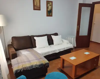 a living room with a couch and a coffee table at El Cano Playa Victoria Grupo AC Gestion in Cádiz