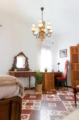 a bedroom with a bed and a mirror and a desk at Ático Imperial GARAJE GRATIS Céntrico Terraza Aire Acond Solarium 2 baños wifi a 1minuto de la Plaza Cabildo in Sanlúcar de Barrameda