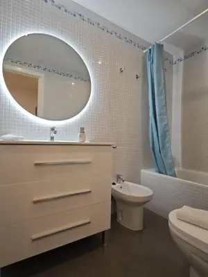 a bathroom with a sink toilet and a mirror at La Terraza de Gades Little Apartments in Cádiz