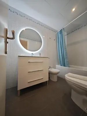 a bathroom with a sink toilet and a mirror at La Terraza de Gades Little Apartments in Cádiz