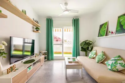 a living room with a couch and a tv at BRISAMAR Rota ATLÁNTICO apartment in Rota