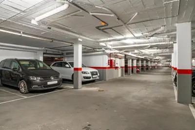 a parking garage with two cars parked in it at BRISAMAR Rota ATLÁNTICO apartment in Rota