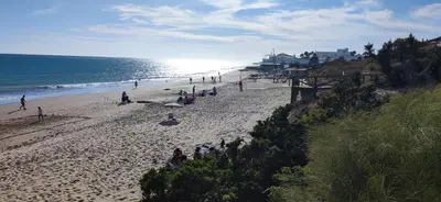 a group of people on a beach near the ocean at BRISAMAR Rota ATLÁNTICO apartment in Rota