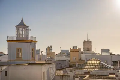 a building with a tower on top of a city at Casa del Sur in Cádiz
