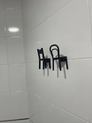 a pair of black chairs hanging on a wall at apartamentos Bandera in Jerez de la Frontera
