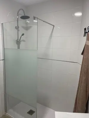 a shower with a glass door in a bathroom at apartamentos Bandera in Jerez de la Frontera