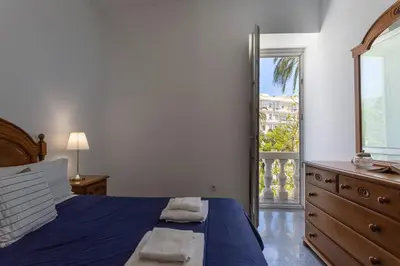 a bedroom with a bed and a dresser and a window at Apartamentos El Capitan Veneno by Cadiz4Rentals in Cádiz