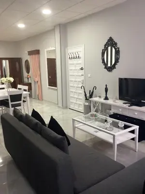 a living room with a couch and a table at María y Juan Apartamento con Garaje in Sanlúcar de Barrameda