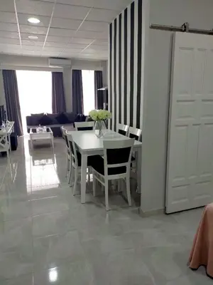 a dining room with a white table and chairs at María y Juan Apartamento con Garaje in Sanlúcar de Barrameda