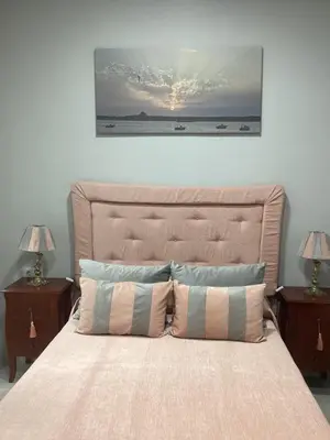 a bedroom with a large bed with two night stands at María y Juan Apartamento con Garaje in Sanlúcar de Barrameda