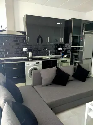 a living room with a couch and a kitchen at María y Juan Apartamento con Garaje in Sanlúcar de Barrameda
