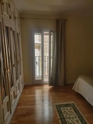 a room with a bed and a door to a balcony at Cádiz San Pedro in Cádiz