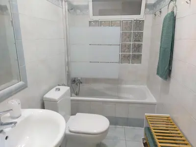 a bathroom with a toilet and a sink and a bath tub at Cádiz San Pedro in Cádiz
