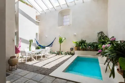 a courtyard with a swimming pool in a house at Eva Recommends Sanlúcar City & Pool in Sanlúcar de Barrameda