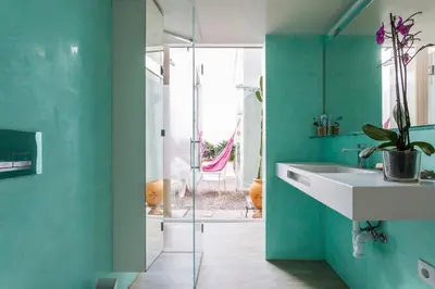 a bathroom with a white sink and green walls at Eva Recommends Sanlúcar City & Pool in Sanlúcar de Barrameda