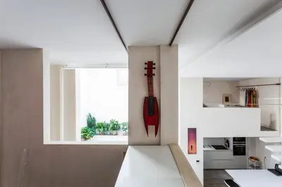 a guitar on a wall in a kitchen with a window at Eva Recommends Sanlúcar City & Pool in Sanlúcar de Barrameda