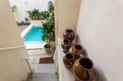 a group of vases on a wall next to a pool at Eva Recommends Sanlúcar City & Pool in Sanlúcar de Barrameda