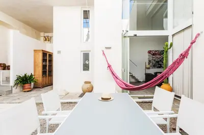 a room with a hammock in a house at Eva Recommends Sanlúcar City & Pool in Sanlúcar de Barrameda
