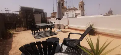 a balcony with chairs and a table on a building at Catedral VIEW Apartment by Cadiz4Rentals in Cádiz