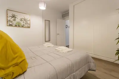 a white room with a bed with two towels on it at Catedral VIEW Apartment by Cadiz4Rentals in Cádiz