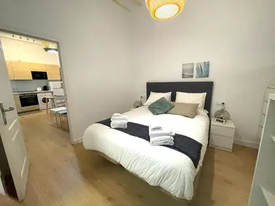 a bedroom with a large bed with towels on it at El Aljibe de Botica in Cádiz