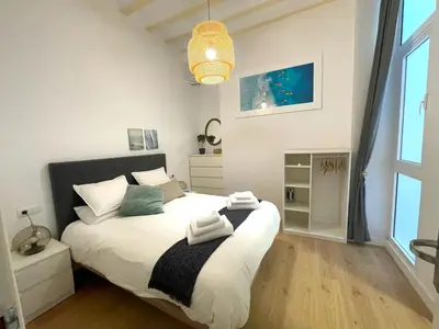 a bedroom with a bed with towels on it at El Aljibe de Botica in Cádiz