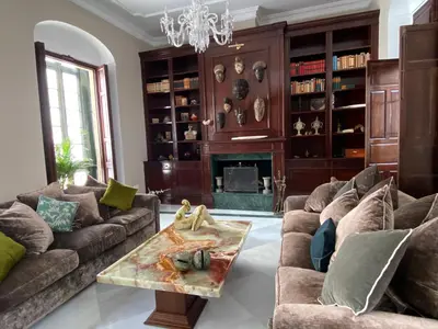 a living room with a couch and a table at Casa Palacio Ánima in Jerez de la Frontera