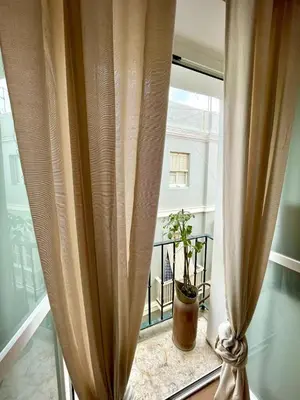 a window with a potted plant sitting on a window sill at GATU PREMIUM Villa Galeona, con terraza privada chillout in Cádiz