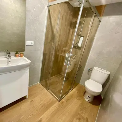 a bathroom with a shower and a toilet and a sink at GATU PREMIUM Villa Galeona, con terraza privada chillout in Cádiz