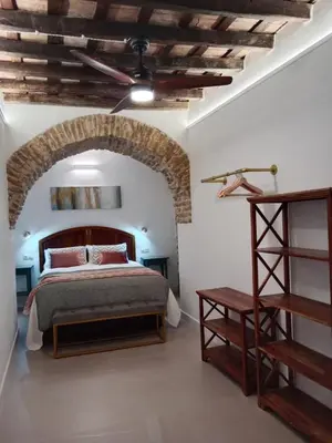 a bedroom with a bed and a ceiling at Casa del Sacramento - CASITA CON ENCANTO in Medina Sidonia