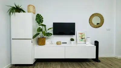 a white cabinet with a tv on top of it at Casa Populi entre Catedral y Ayuntamiento in Cádiz