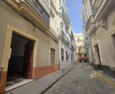 an empty alley with a building with a garage at Casa Populi entre Catedral y Ayuntamiento in Cádiz