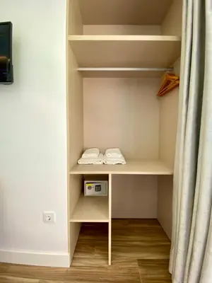 a closet with a shelf with a clock on it at VISTA LAGO VILLE in Chiclana de la Frontera