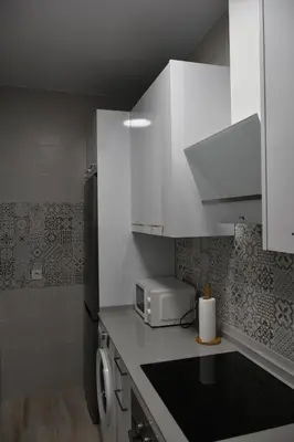 a kitchen with white cabinets and a microwave at Sweet Arco Rosa Zona Centro in Cádiz