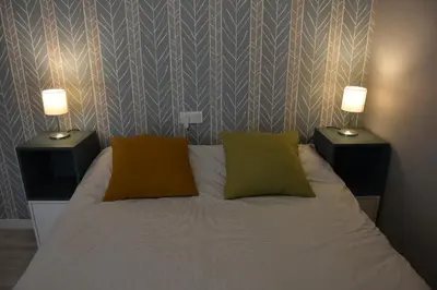 a bedroom with a bed with two lamps on it at Sweet Arco Rosa Zona Centro in Cádiz
