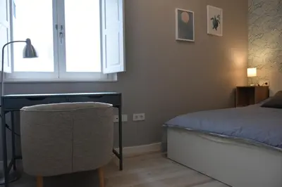 a bedroom with a desk and a bed and a window at Sweet Arco Rosa Zona Centro in Cádiz