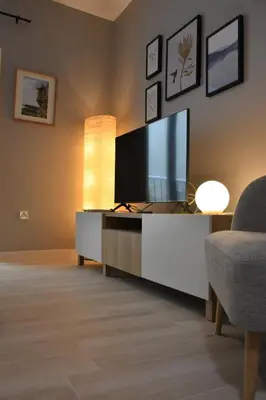 a living room with a flat screen tv and a couch at Sweet Arco Rosa Zona Centro in Cádiz