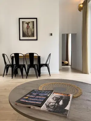 a living room with a table with a magazine on it at La Casa de Lima Little Apartments in Cádiz